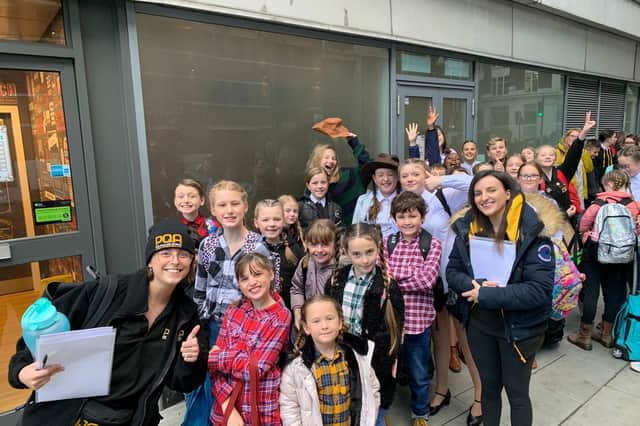 Smiles all around as students from the Pauline Quirke Academy arrive in London.