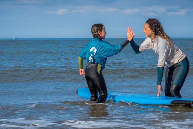 A student and a mentor enjoying the waves.