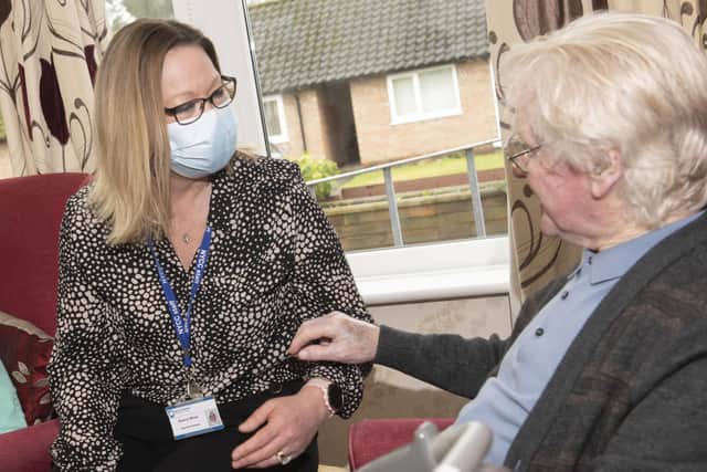 Sharon Moss sharing stories with a resident at Benkhill Lodge