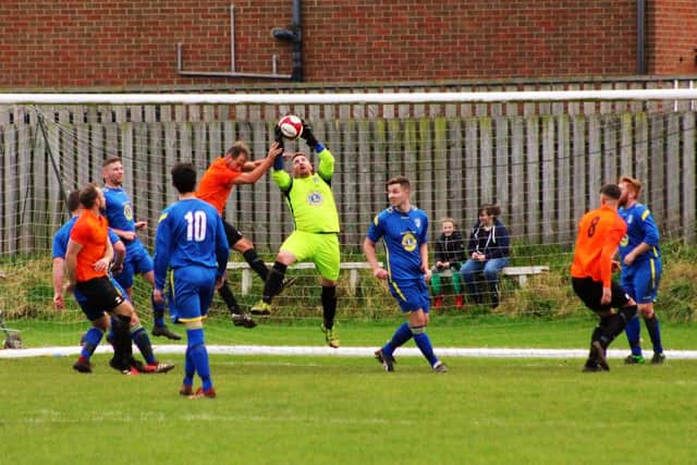 Filey's keeper claims the ball
