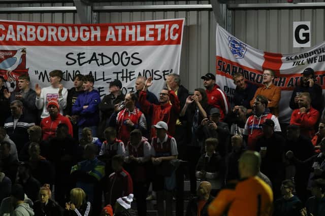 Scarborough Athletic fans cheer their team on at the Flamingo Land Stadium.