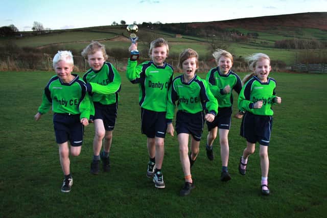 Cross country runners from Danby School with their trophy.