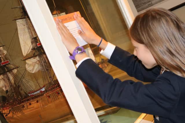 An Eskdale student putting up a sign she has written.
