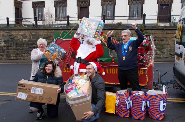 Joe and Courtney delivering the toys to the Rainbow Centre with the help of Santa and Scarborough Lions in 2020