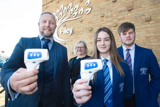 Photo shows Simon Rehill, general manager of Pulsar Instruments, left, with Laura Jenkins, marketing manager and Ebor Academy Filey students Yasmine Gharib, head girl and James Brown-Sill, deputy head boy, who received the handheld thermometers on behalf of Ebor Academy Trust.