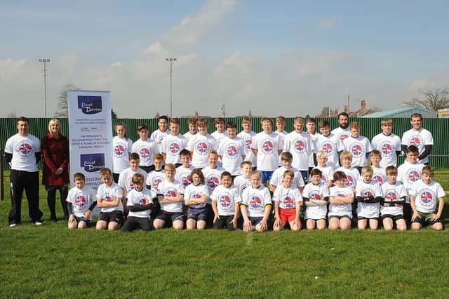This photograph was taken at Bridlington Rugby Club and features a group shot from the rugby school workshop with England sevens captain Rob Vickerman in 2014. Attendees are pictured with with coaches and sponsors. (NBFP PA1417-12a)