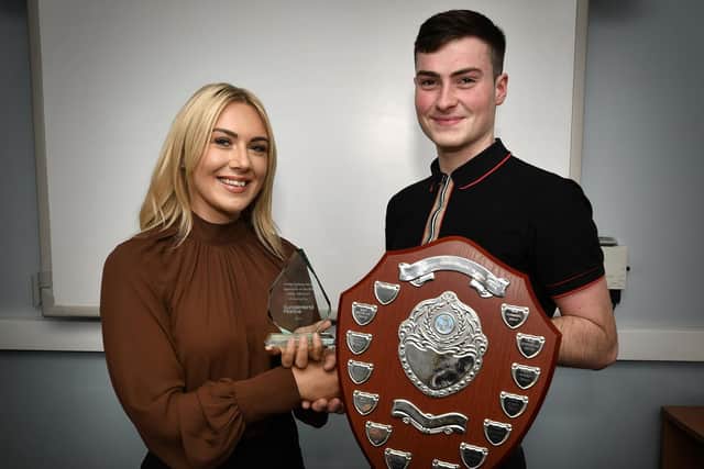 Holly Rowley of Sunderland Marine presents Whitby’s Rory Brickley with his Apprentice of the Year, Sea Fishing award.
215014d