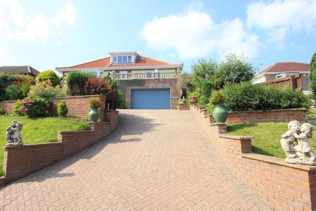 The driveway up to the villa style home in its elevated position.