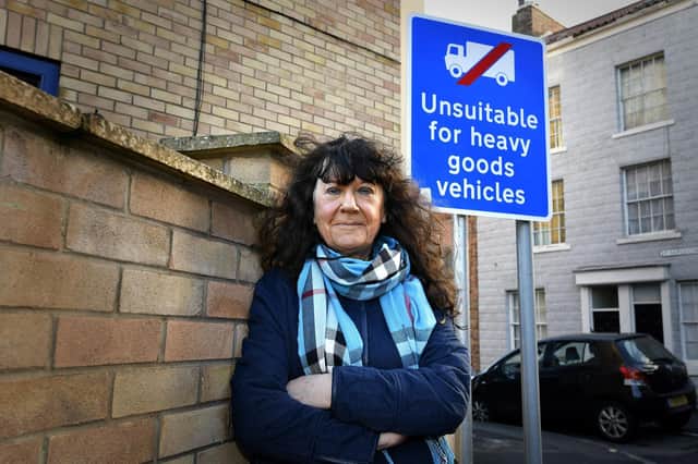 Cllr Janet Jefferson beside one of the new road safety signs she campaigned for on St Sepulchre Street.