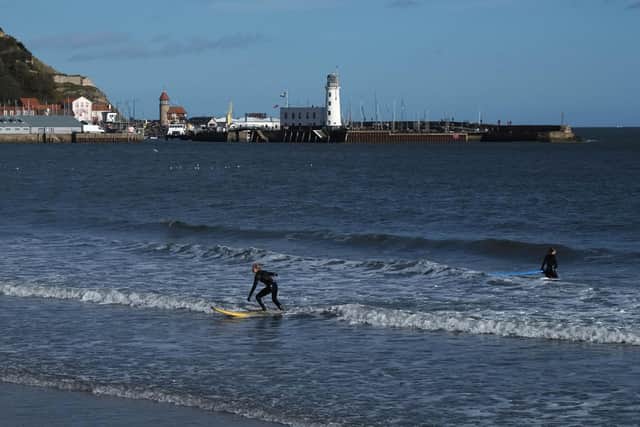 A surfer rides the waves in Scarborough's South Bay.