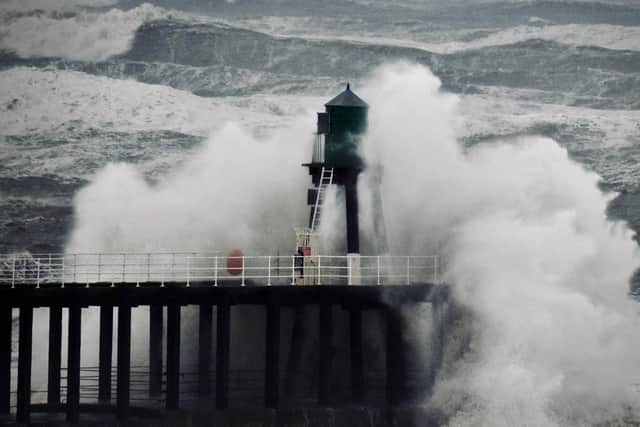 Spectacular image of waves crashing in against the pier in Whitby, taken by Simon James Smith.