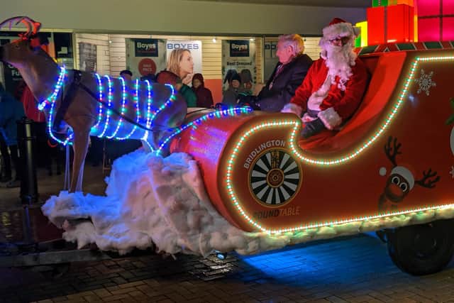 Santa is framed by Carol Jackson as he attended the switch-on event in Bridlington.