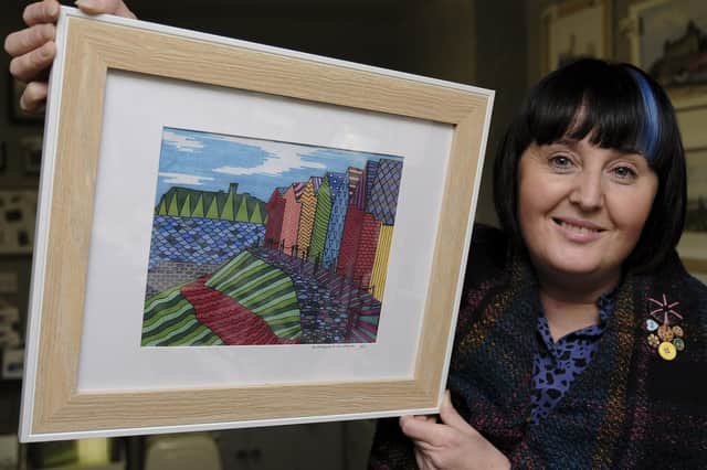 Artist Julie Henderson with one of her pictures inspired by Scarborough's architecture and landscape