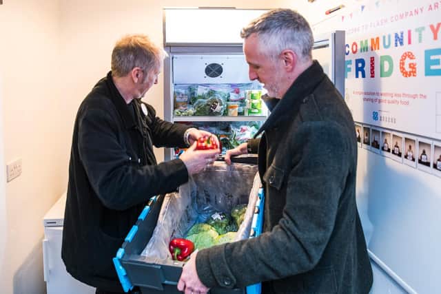 David Owen of Flash Company Arts stocking the fridge with Ed Powell.