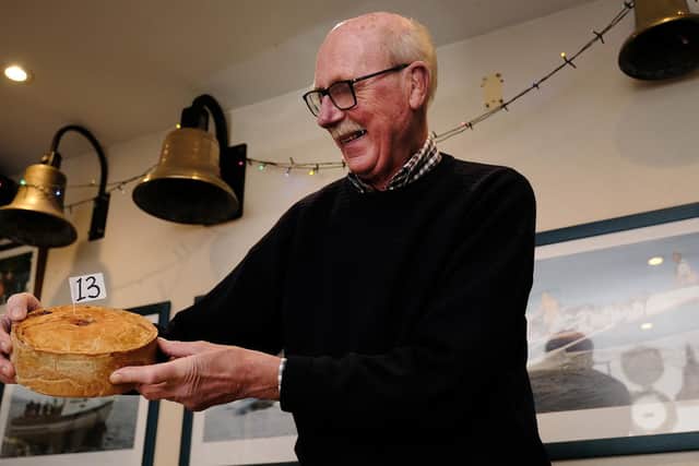Colin Woodhead inspecting one of the entries at Leeds Arms annual prok pie competiton.