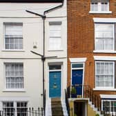 A garden, with steps to the door and railings give the house an attractive frontage.