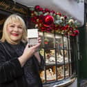 Kay Bradley outside her jewellery store in York with one of the special bracelets she is gifting to NHS workers this Christmas.