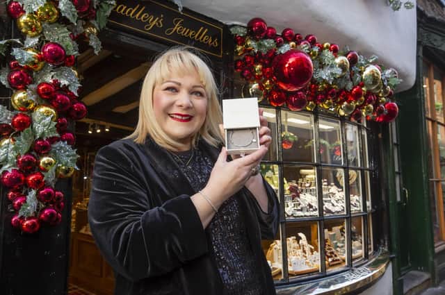Kay Bradley outside her jewellery store in York with one of the special bracelets she is gifting to NHS workers this Christmas.