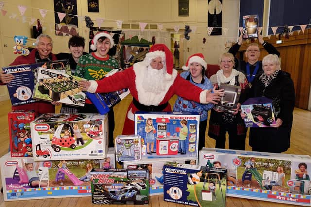 Santa Drops off presents at the Rainbow centre with fundraisers Joe and Courtney Maw..
Left to Right: Rich, Jack and Joe Maw, Santa, Courtney Maw, Rainbow Centres Trish Kinsella, Scarborough Lions Rob Hunter, Carol Turner
