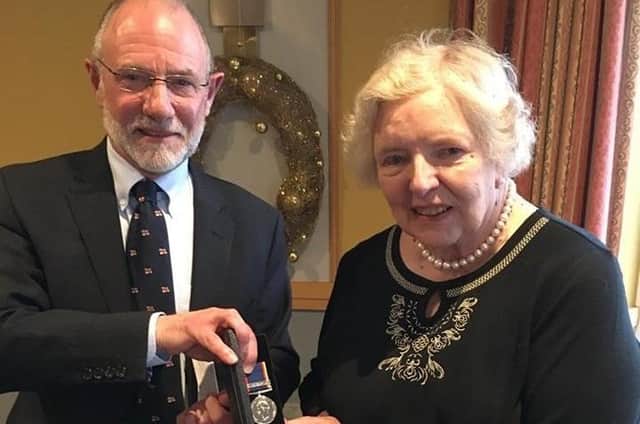 Gillian Bapty recieves her long-service medal for 30 years from Dave Garnett, chair of Bridlington Lifeboat Management Group. Photo courtesy of Bridlington RNLI