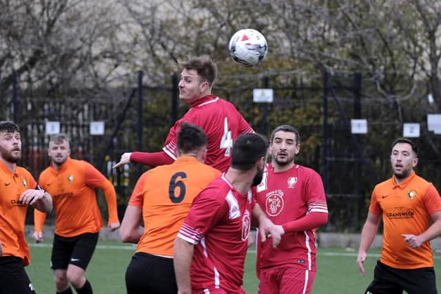 Newlands midfielder Ben Luntley wins a header in the 3-1 win at Edgehill  in the Scarborough Saturday League Division One on Saturday December 11 2021

Photos by Richard Ponter