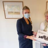 Vicki Davies from Skipton Building Society presents the Rainbow Centre's Trish Kinsella with some much needed pans.