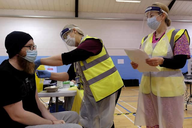 A patient receives their coronavirus vaccine at Scarborough Rugby Club.