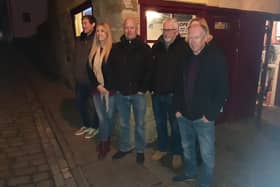 John Field, Chair of the Civic Society and members of the Fortune family outside Fortune's kipper house on Henrietta Street, Whitby.