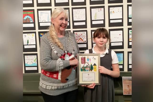 Mayor of Whitby, Cllr Linda Wild, with Christmas card competition winner Olivia Owen-Taylor, 8, and her winning card.