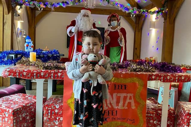 Evie Armstrong receives an early visit from Father Christmas at Leeds Children's Hospital.