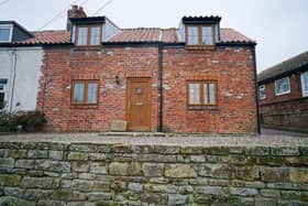 Exterior view of Rambler Cottage, in its village setting near Whitby.