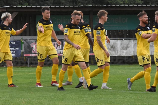 Town players celebrate a goal away from home