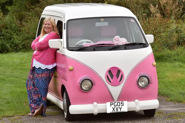 Janette Wilkinson with her pink camper van she has called Bagpuss - and a pink and white striped fluffy toy has pride of place on the dash board