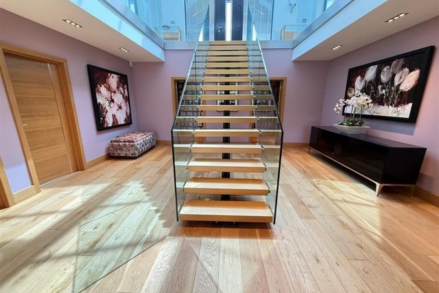The striking hallway has a central staircase.
