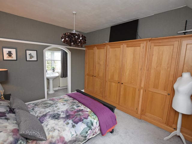 The main bedroom of four has an en suite shower room.