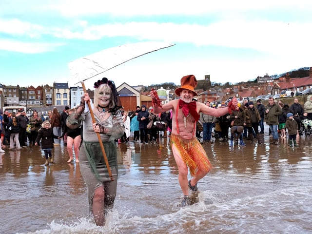 Participants charging into the sea