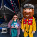 Jessica Redland at Scarborough Lifeboat Station with mascot Stormy Stan who features in her The Starfish Café series
