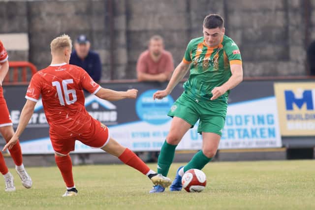 Brid Town sub Charlie Dunkerley gets stuck in against Ashington. Photo by TCF Photography
