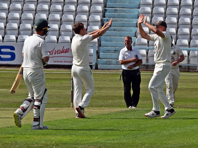 Jack Redshaw is congratulated on his first wicket.