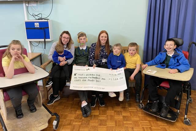 Hannah Neville presents a cheque for £1,584 to Springhead School