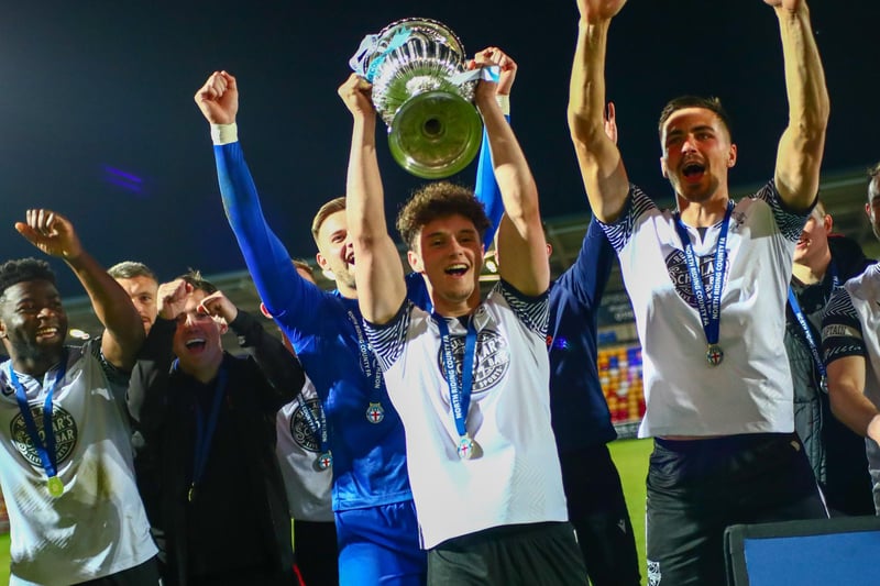 Young sub and goalscorer Billy Leach lifts the North Riding FA Senior Cup while his teammates celebrate the 4-1 win against South Park Rangers.