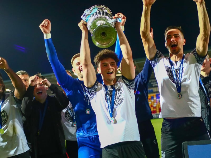 Young sub and goalscorer Billy Leach lifts the North Riding FA Senior Cup while his teammates celebrate the 4-1 win against South Park Rangers.