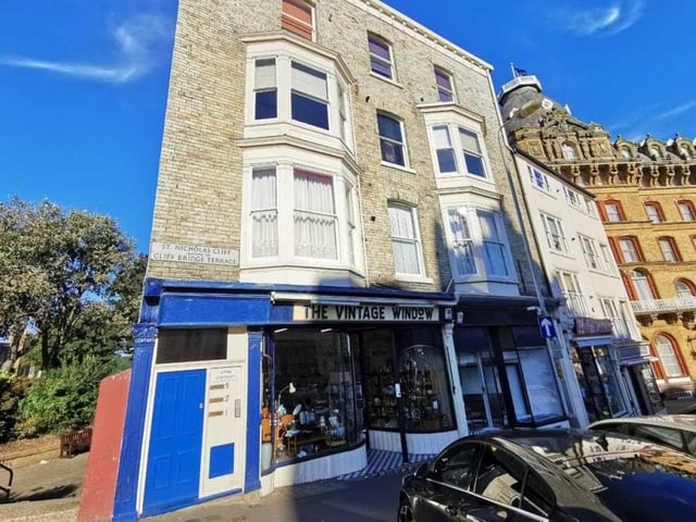 The attractive exterior of the apartment building, and surrounding structures.
