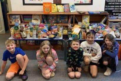 A culture of care in action: children working hard to collect donations for the foodbank.