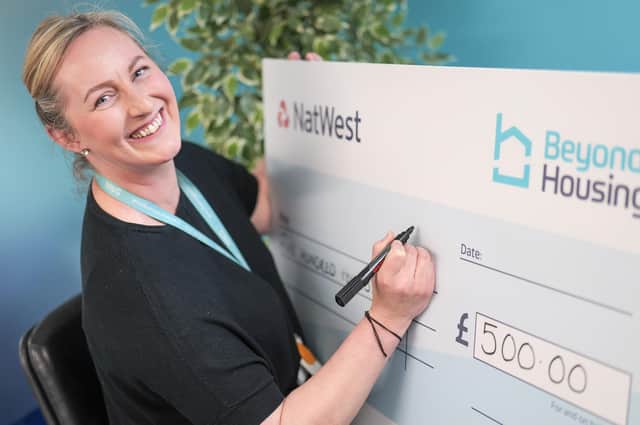 Stephanie Lake, Community Partnership & Engagement Manager at Beyond Housing, gets set to write out the first Beyond Housing Community Fund cheque for the 2025-2026 programme.