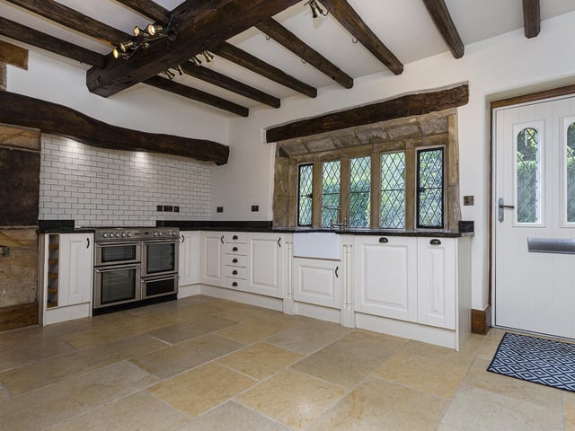 Dating back to the seventeenth century, the kitchen has exposed beams and lintels, with timber fitted units and granite worktops.