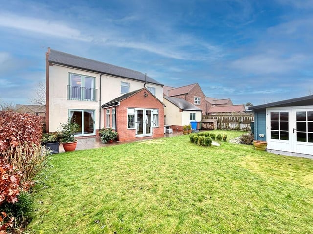 A rear view of the property from its lawned garden.