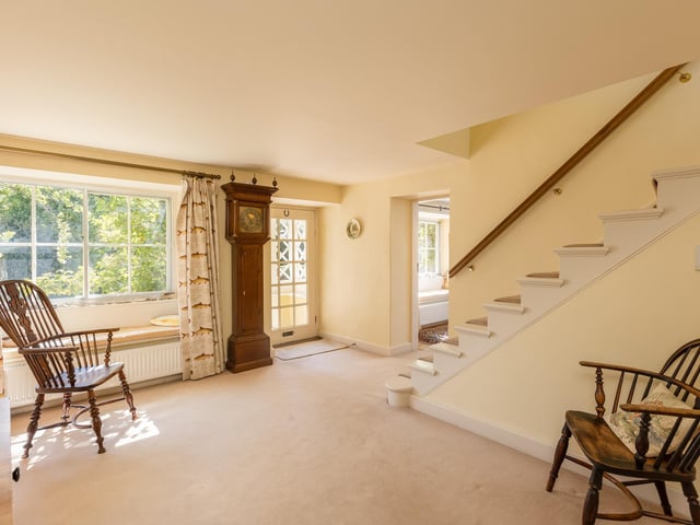 An open staircase leads up to the first floor from the entrance hall.