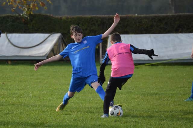 Heslerton Under-14s (blue) take on West Pier