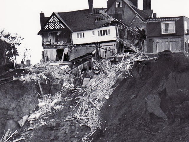 Rubble from the hotel spills down the cliff face.